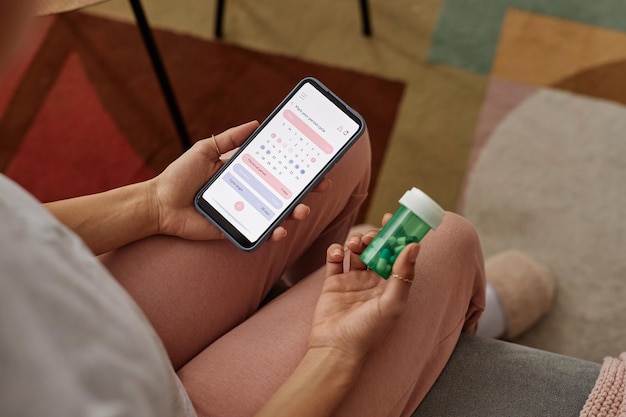 A close-up view of a smartphone screen displaying a user-friendly interface of a digital health app that tracks medication adherence, with clear reminders pills and dosage instructions.