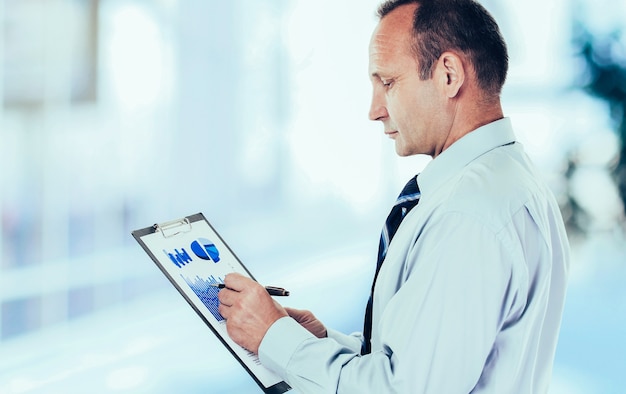 A medical professional reviewing data on a computer screen, showcasing Biofourmis's Biovitals® platform, with graphs and charts representing patient vital signs and health metrics.