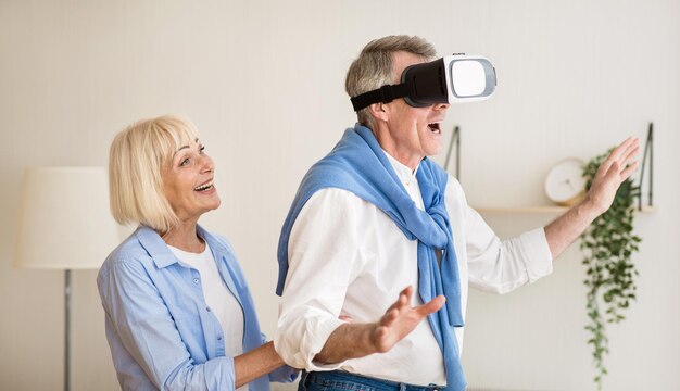 A physical therapist guiding a patient through a VR rehabilitation program. The patient is performing arm exercises while wearing a VR headset, and the therapist is providing feedback.
