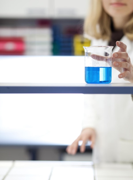 A side-by-side comparison graphic showing a traditional chemistry lab with beakers and equipment on one side, and a student using a virtual reality headset to conduct a similar experiment on the other, emphasizing the differences and similarities between the two approaches.