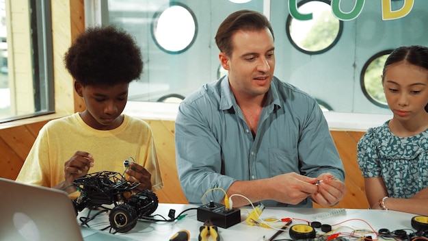 Students in a well-equipped physics lab, working together on an experiment involving circuits and multimeters, highlighting the collaborative and tactile nature of hands-on learning.