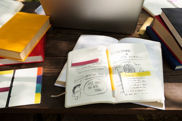 A close-up shot of an open textbook with annotations, highlighting the ease of customization and adaptability that OER provides. The focus is on the handwritten notes and highlighted sections.