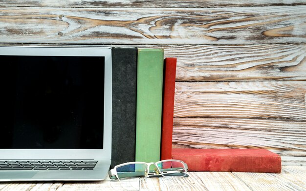A split-screen image contrasting traditional, expensive textbooks on one side with digital, open educational resources on a tablet on the other side, visually emphasizing the difference in cost and accessibility.