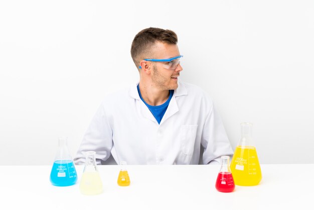 A scientist in a lab coat looking through a microscope, with beakers and other lab equipment around them. The image has a bright and clean aesthetic, symbolizing modern research.