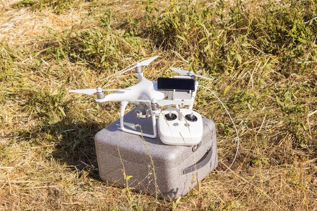 A close-up of a drone equipped with sensors and cameras, hovering above a field. The image highlights the multiple applications of drone technology in agriculture and the need for specific regulations in this sector.