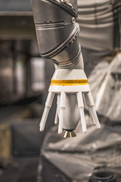 A close-up shot of a robotic arm performing a precise manufacturing task in a modern factory, highlighting the use of advanced technology in US manufacturing processes.