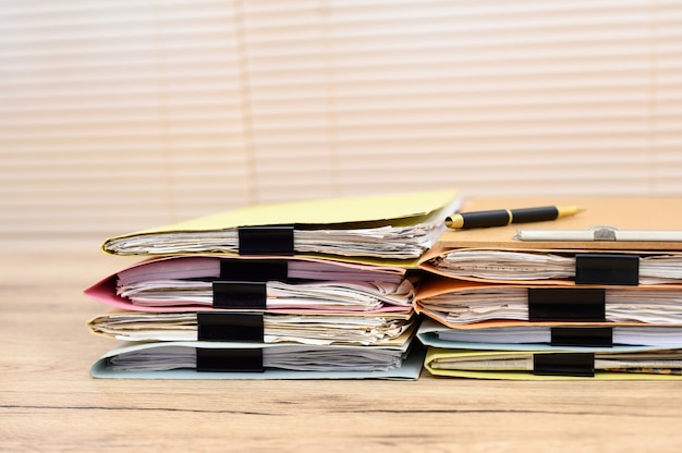 A close-up shot of various receipts, bills, and financial documents organized in a folder, with a focus on the labels indicating home office expenses, internet, and equipment costs. Soft, natural light highlighting the importance of documentation.