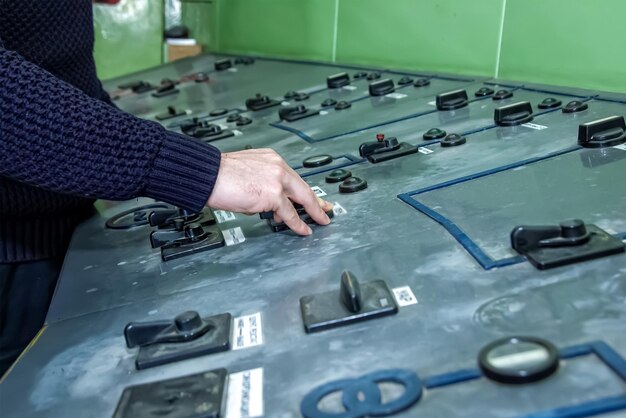 A close-up shot of a technician working on a large-scale battery storage system, highlighting the technological expertise required for energy storage solutions.