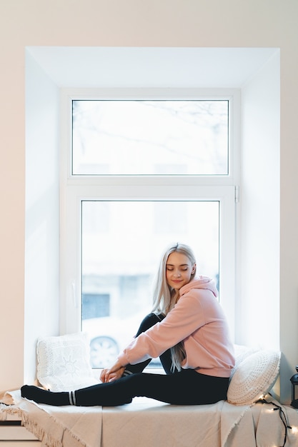 A split-screen image. On one side, a person lounging at home with a relaxed expression, representing potential disincentive to work. On the other side, a person working enthusiastically on a laptop with a bright, innovative workspace, representing potential incentive for entrepreneurship.