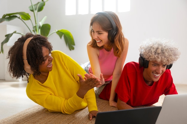 A diverse group of professionals is shown participating in a virtual team-building activity on a video conferencing platform. They are laughing and engaged, demonstrating effective remote team cohesion.