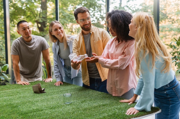 A group of employees participating in a team-building activity outdoors, laughing and interacting, symbolizing a positive and supportive company culture.